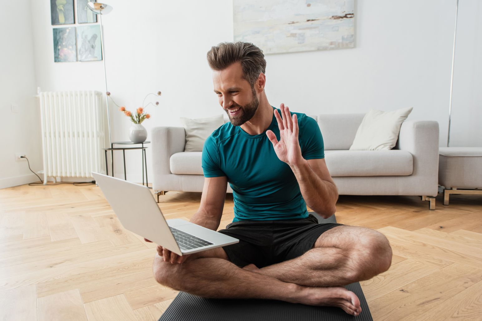 Online Yoga YTT Student Smiling With Laptop Selecting a 200 hour yoga course